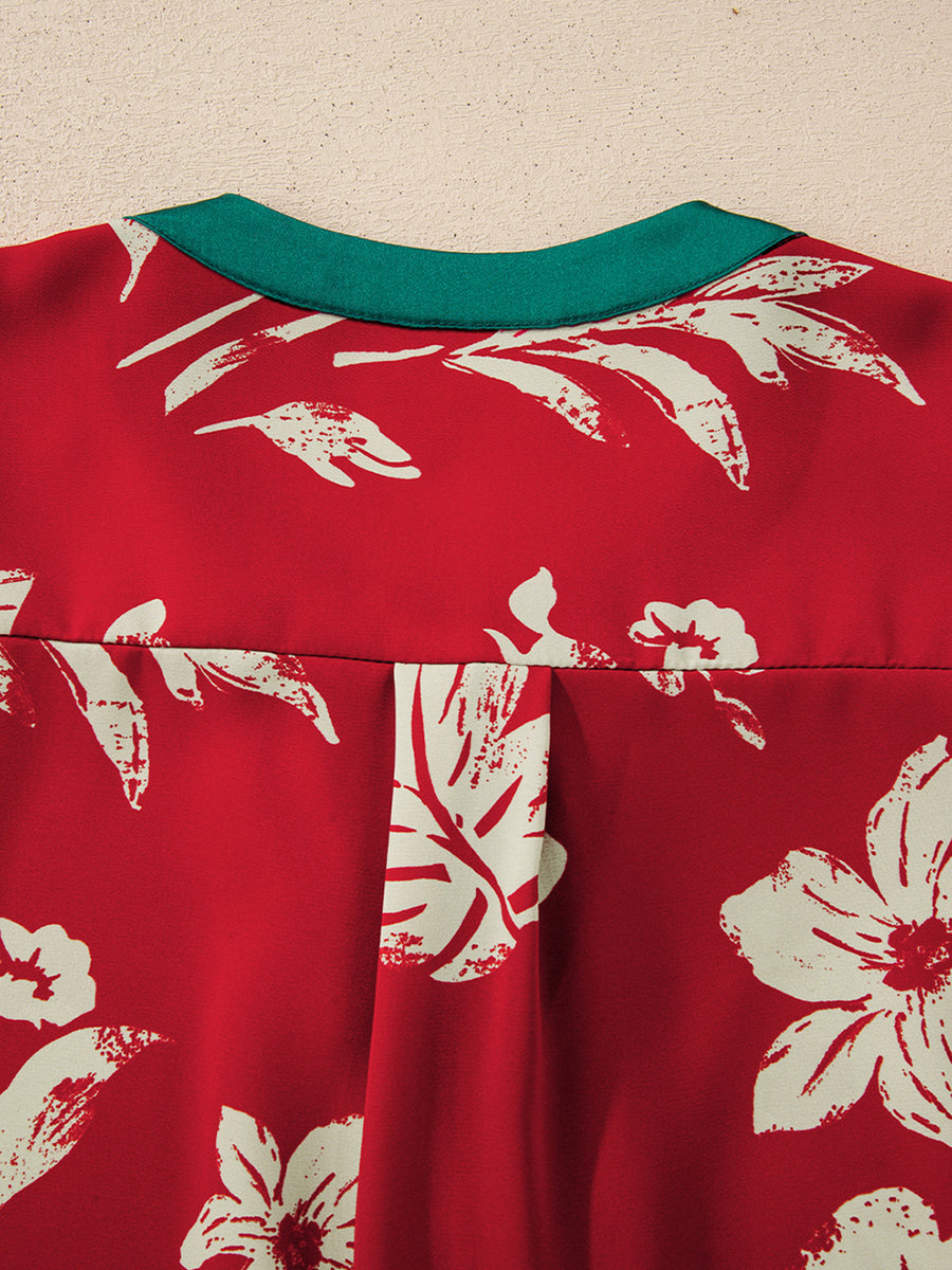 Red floral print blouse with green trim and pleat detail