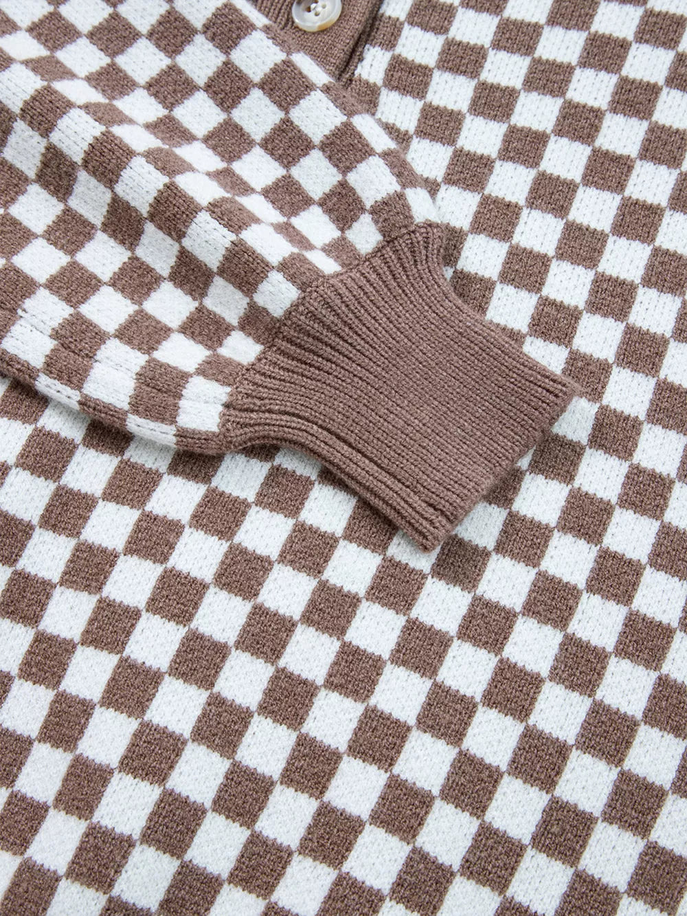 cream pullover sweater with half-button and checkerboard