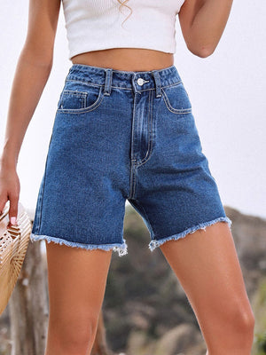 Medium wash denim shorts with frayed hem and a high waist.