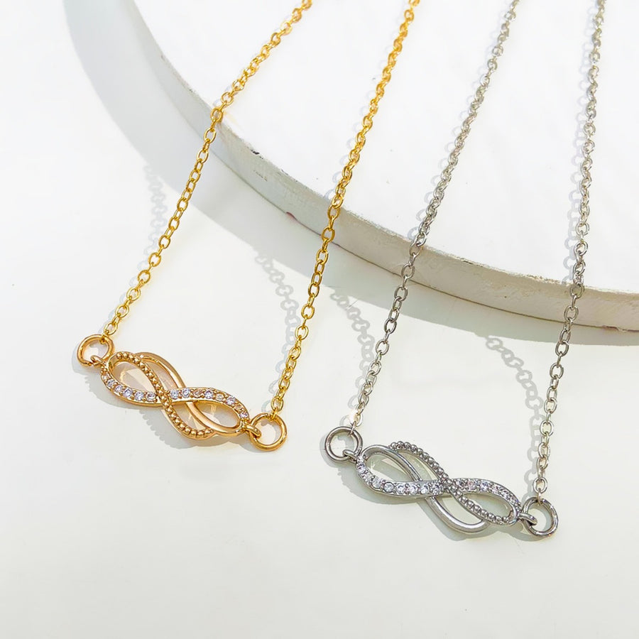 Gold and silver infinity knot charm bracelets with cubic zirconia details
