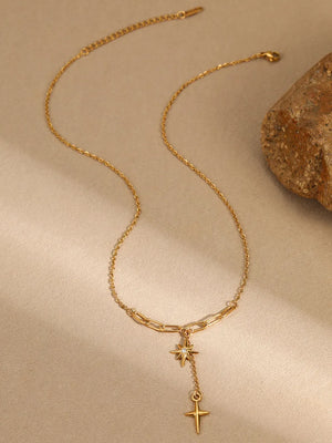 clear necklace featuring pendant and star and cross pendant