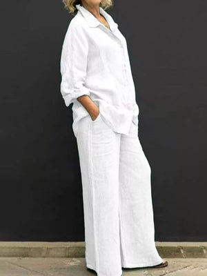 White button-down collared two-piece set with wide-leg pants and rolled sleeves.
