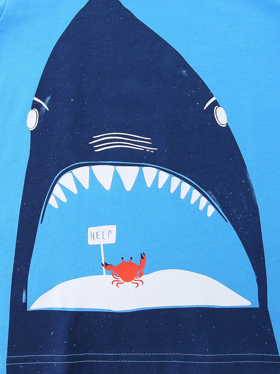 Blue cotton t-shirt with a graphic of a shark's open mouth, a crab holding a HELP sign on an island.