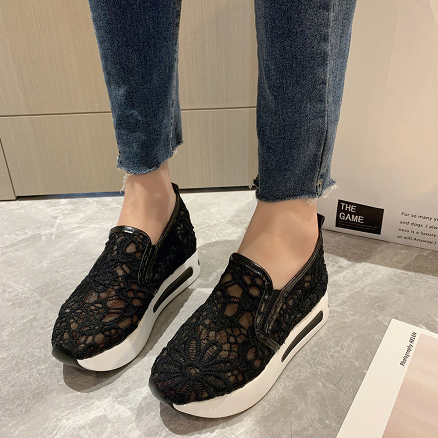Black lace mesh slip-on flats with white platform soles.