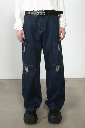 Dark wash denim wide-leg jeans with distressed panel pockets and a relaxed fit.