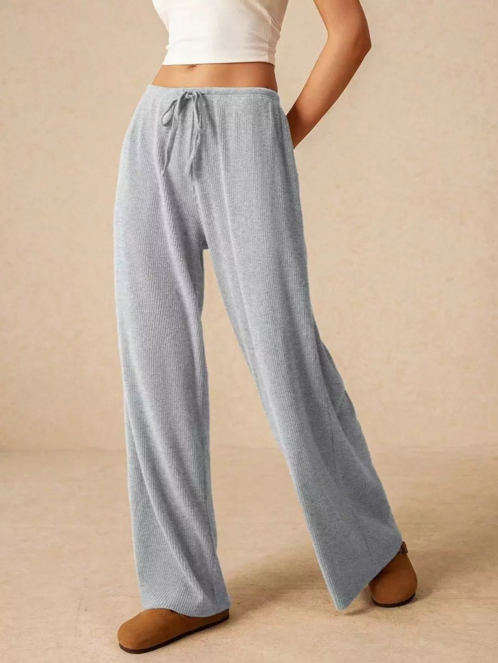 Gray ribbed wide-leg drawstring pants with a relaxed fit.