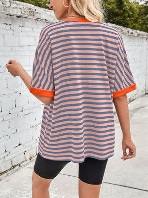 Striped Breton tee with orange trim and short sleeves, worn with black shorts.