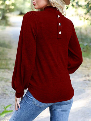 Burgundy mock neck puff sleeve top with button back detail.