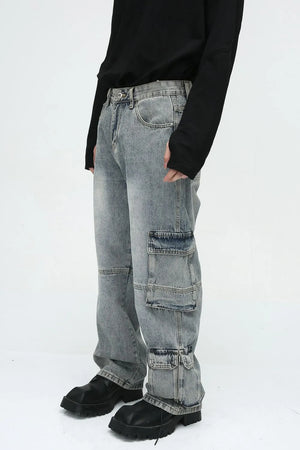 Medium wash denim cargo pants with multiple utility pockets and wide legs.