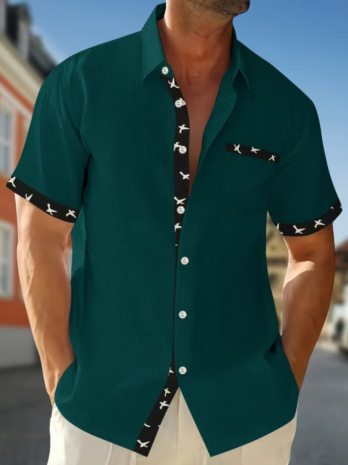 Short sleeve button-up shirt in olive green with waffle texture and bird print trim