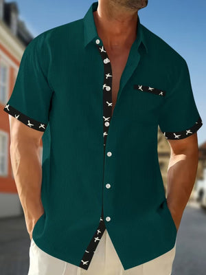 Short sleeve button-up shirt in olive green with waffle texture and bird print trim