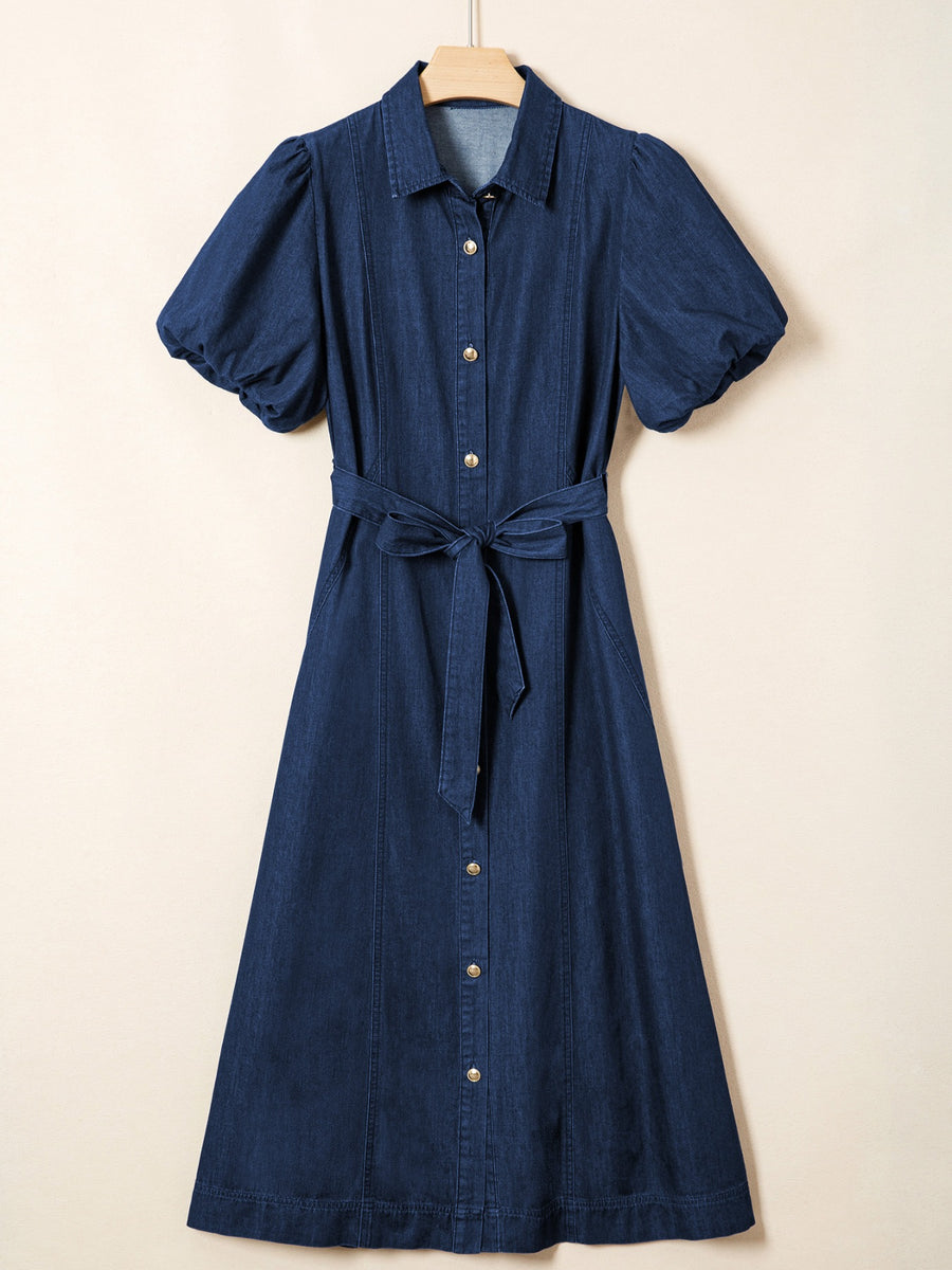 Denim midi dress with puff sleeves, collared neckline, button front, and tie belt.