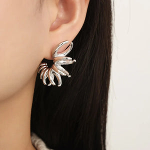 Sculptural silver petal drop earrings with a unique spiral design.