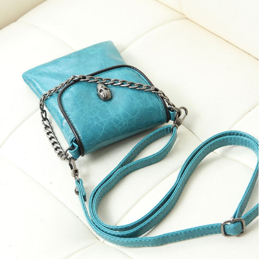 crossbody bag in teal with skull embellishment and mini