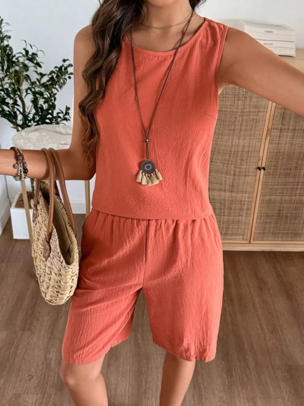 Orange-red relaxed fit tank and shorts set with round neckline and elastic waist shorts.