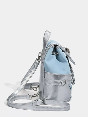 Charming mini backpack in blue and silver with heart flap detail and chain strap.