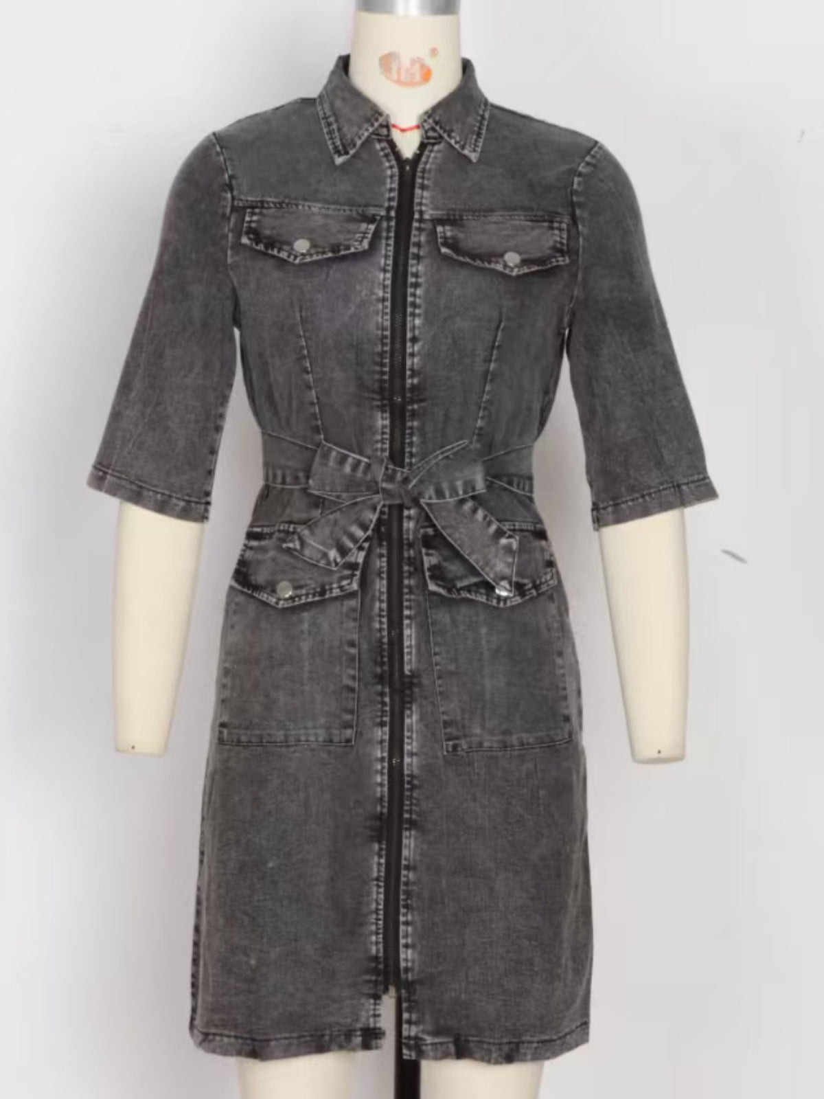 Grey denim shirt dress with zipper front, tie waist, and chest pockets.