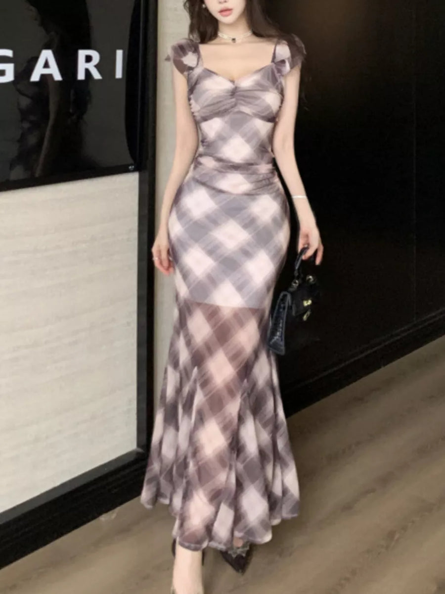 Ruched plaid bodycon maxi dress with sweetheart neckline and sheer mermaid skirt.