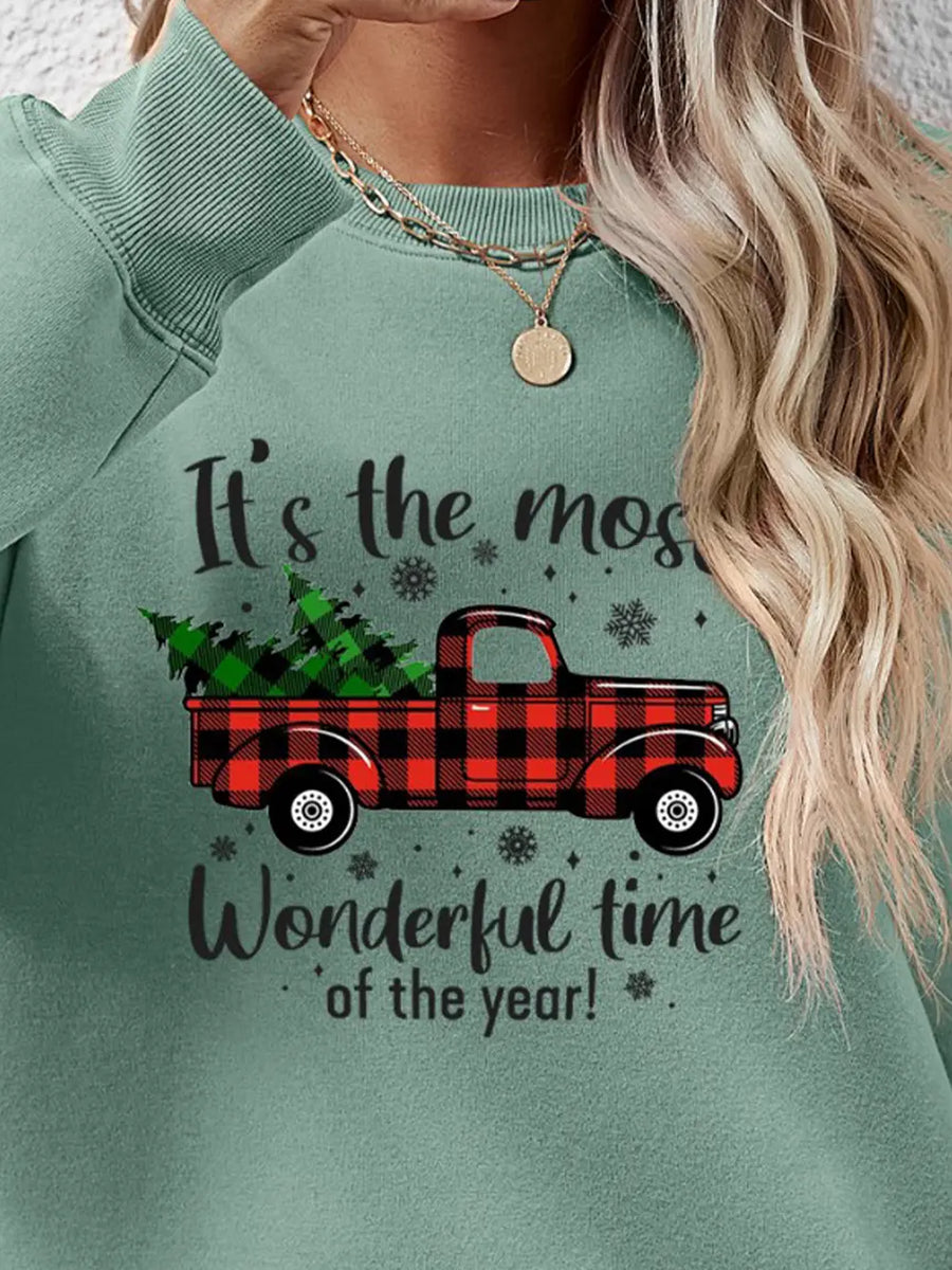 Green crewneck sweatshirt with buffalo plaid truck graphic and holiday text.