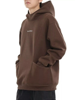 Oversized coffee graphic hoodie with high neck and front pockets.
