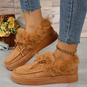 Brown suede loafers with shearling trim and bow detail.