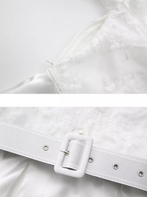 White lace maxi dress with lantern sleeves, featuring a zip closure and a white belt with a square buckle.