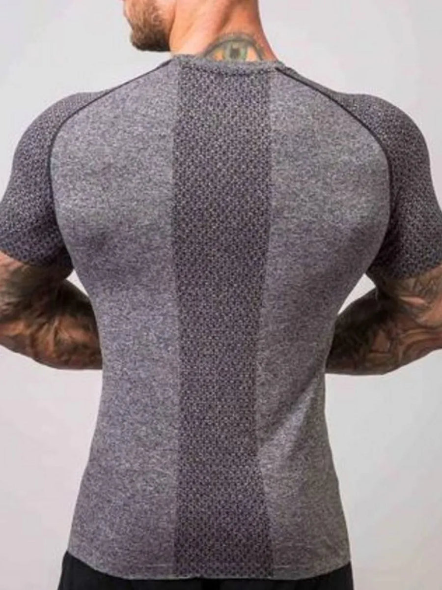 Gray performance raglan tee with textured paneling and breathable fabric.