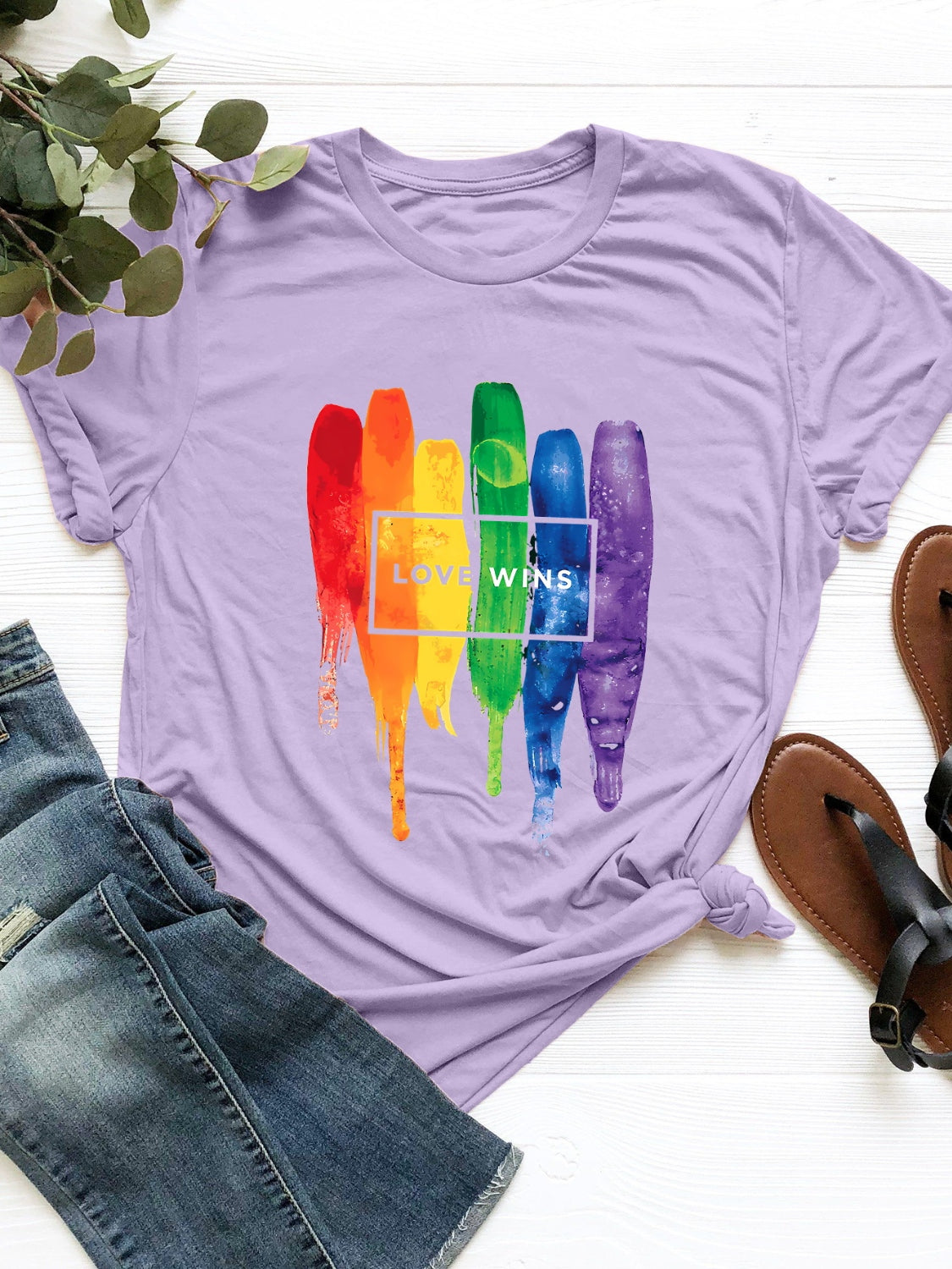 Lavender t-shirt with rainbow brushstrokes and "Love Wins" text graphic