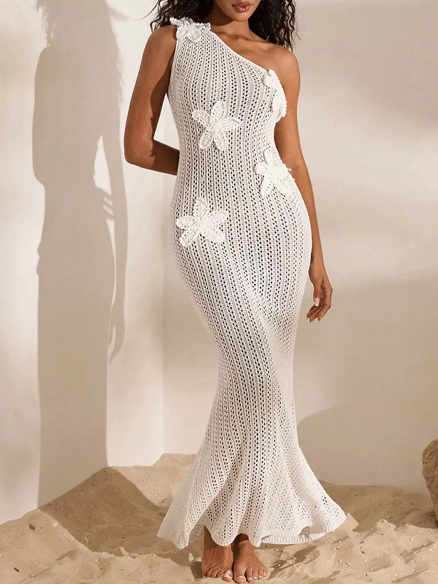 White crochet one-shoulder maxi dress with floral appliques and a flared hem