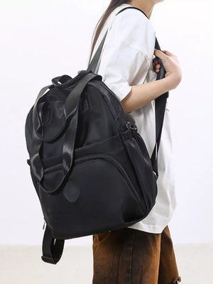 Black Oxford cloth backpack with adjustable straps and top handles.
