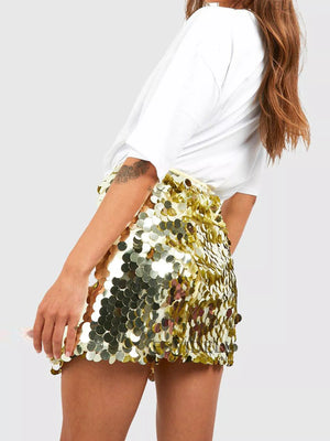 Women's gold sequin mini skirt with all-over circular sequin embellishments.