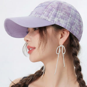 Purple plaid cotton baseball cap with embroidered detail and adjustable strap.