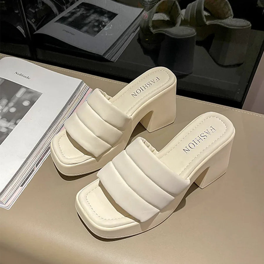 Ivory padded platform mules with block heel and square toe.