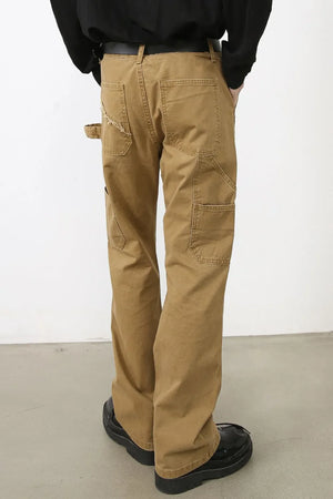 Camel wide leg carpenter trousers with distressed loop detail and multiple pockets.