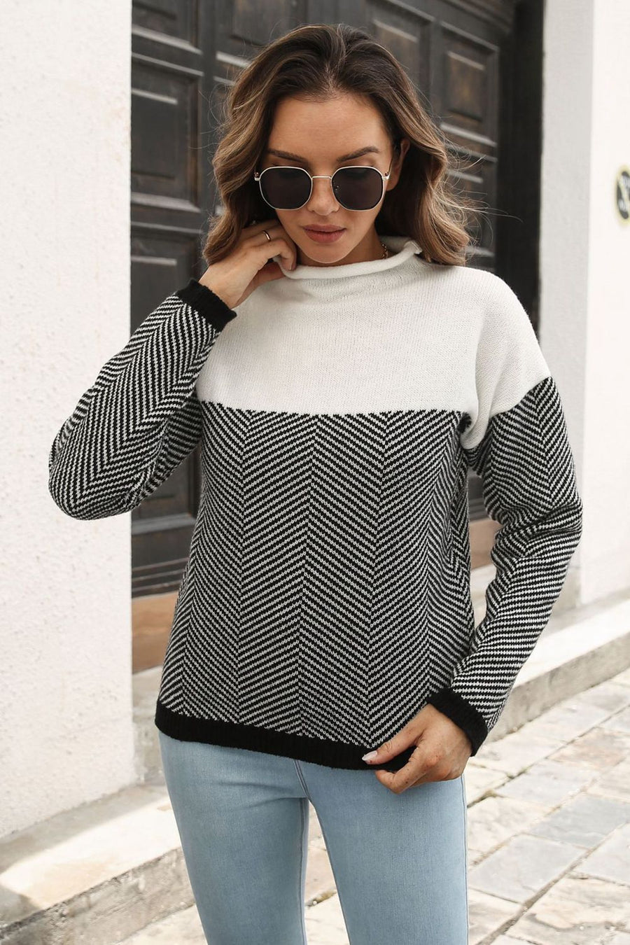 Chevron block mock neck knit sweater in black and white acrylic with a herringbone pattern.