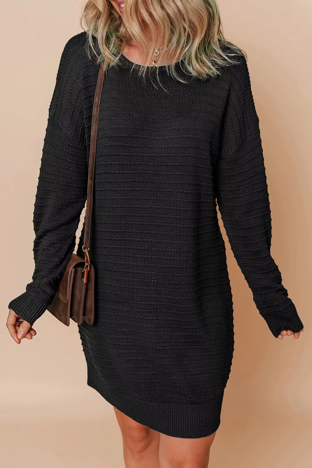 sweater dress in black featuring stretch and shift fit