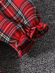 Baby dress with red plaid pattern and ruffled cuffs.