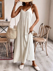 Effortless V-neck maxi dress in cream with spaghetti straps and a flowing skirt.
