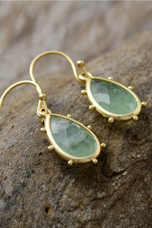 Teardrop earrings with light green amethyst and gold detailing.