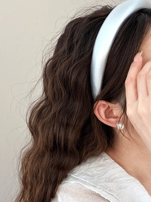 Glossy padded headband in silver, a chic hair accessory for adults.