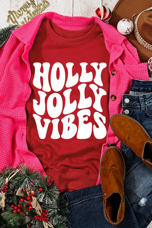 Red graphic sweatshirt with white "Holly Jolly Vibes" text, crew neck, long sleeves.