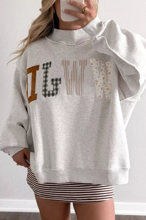 sweatshirt in heather gray featuring letter graphic and loose fit