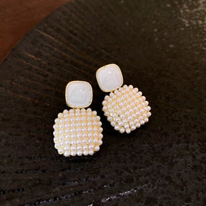 earrings in gold with figurative and angel motif