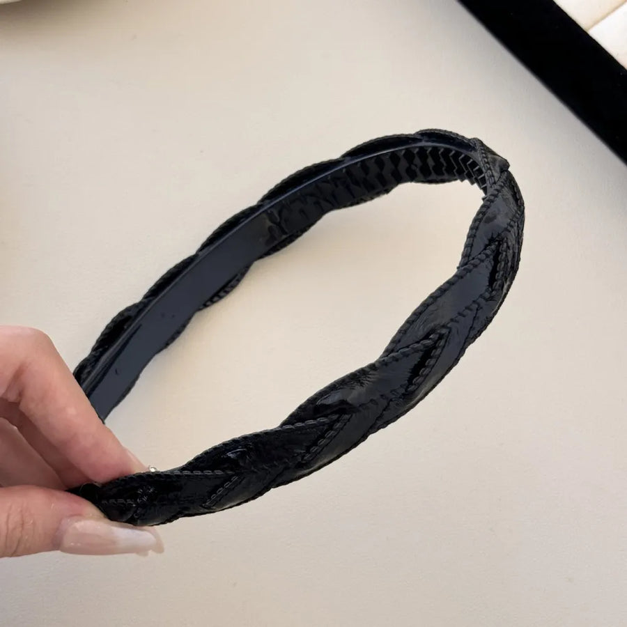 Black woven faux leather headband with braided detail
