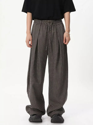 Plaid wide-leg relaxed fit pants with adjustable drawstring waist.