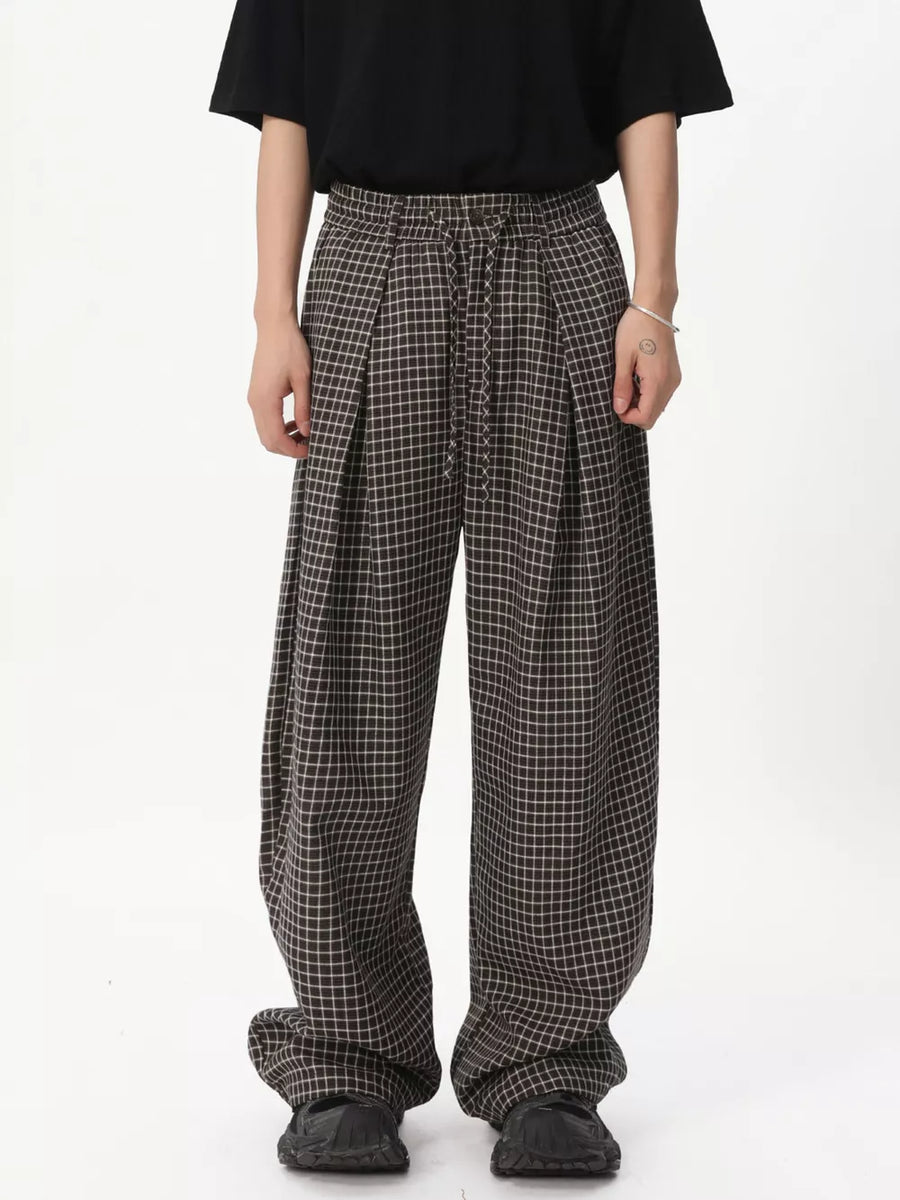 Plaid wide-leg relaxed fit pants with adjustable drawstring waist.