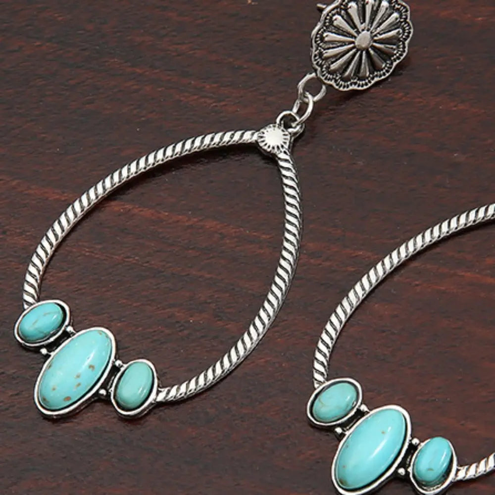 Southwestern teardrop earrings with turquoise stones and silver alloy.