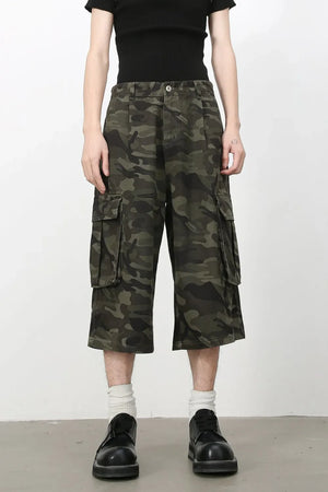 Green camouflage pleated culotte cargo shorts with buttoned flap pockets.