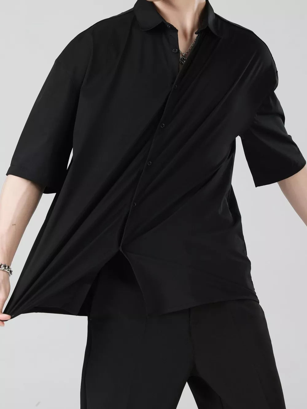 Black short sleeve button-down shirt for men, showing stretch fabric and relaxed fit.