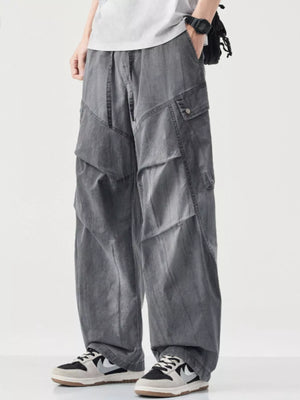 Loose fit grey cargo pants with drawstring and multiple pockets.